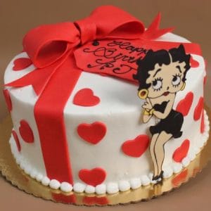 The BD-141 is a round cake featuring red hearts, a big red fondant bow, and a Betty Boop figure. Presented on a gold board with a red "Happy Birthday" tag.