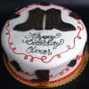 The cb-033 is a round white birthday cake with cowboy boot decorations, red icing swirls, and "Happy Birthday Omar" written in black icing on top.