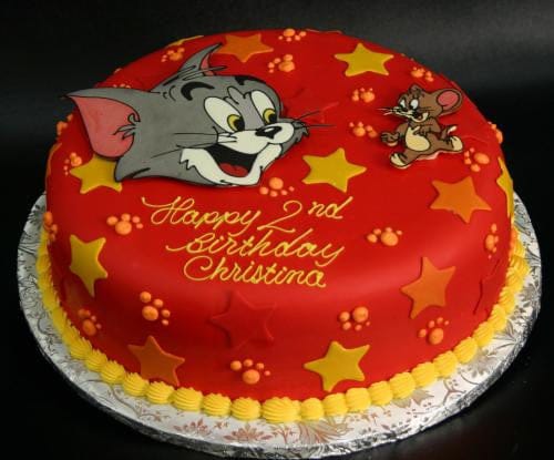The CB-010F is a round red birthday cake with yellow stars, Tom and Jerry images, and yellow icing on the base. "Happy 2nd Birthday Christina" is written in yellow icing.
