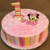 The CB-001H is a round pink birthday cake decorated with white polka dots, striped sides, a large striped number one topper, and a fondant cartoon mouse with a pink bow. "Happy Birthday Victoria" is written in pink icing.