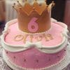 Celebrate a 6th birthday with cake CB-016B: a pink cake featuring gold accents, white bows, the name Olivia, and topped with a gold crown and pink number 6.