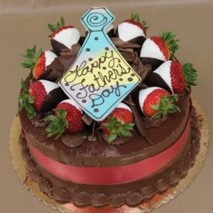 The FD-006 Tiramisu cake is decorated with chocolate-dipped strawberries, chocolate shavings, a red ribbon, and a tie-shaped cookie that says "Happy Fathers Day.