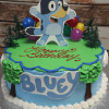 The SC-080 Bluey cake is a round birthday cake with tree and balloon decorations, a big edible Bluey cartoon topper, "Happy Birthday" in red icing, and "BLUEY" in blue letters on the side.
