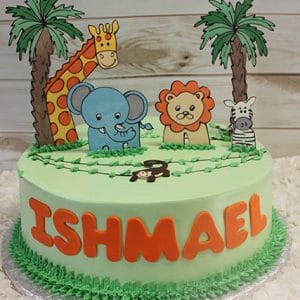 BB-034 is a round cake with green icing, featuring giraffe, elephant, lion, zebra, and monkey cutouts, two palm trees, and the name ISHMAEL in bold orange letters on the side.