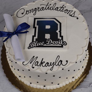 A white Randolph High School cake (GC-001E) with black polka dots, "Congratulations Makayla" in black icing, the Blue Devils logo, and a blue ribbon-tied diploma topper.