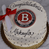 A GC-001J Brockton High School cake featuring white icing with black polka dots, “Congratulations Makayla” in black, the Brockton Public Schools logo in the center, and a rolled diploma with a red ribbon on top.