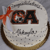 GC-001K Oliver Ames High School round white cake with black polka dots, OA tiger logo, rolled diploma with orange ribbon, and "Congratulations Makayla" in black icing.