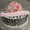 The BD-036E Cheetah Roses cake features round black and white leopard print icing, pink and white frosting roses, and a white "Happy 13th Birthday Analisa!" banner in pink script, presented on a silver tray.
