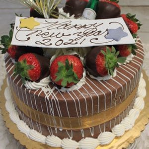 The NY-006 Chocolate Oreo is a round chocolate cake decorated with gold ribbon, chocolate-dipped strawberries, whipped cream, a small bottle accent, and a "Happy New Year 2021!" sign on top, presented on a gold cake board.