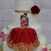 The WD-001T is a three-tier white cake with pearls, gold ribbon, red and pink roses, and a dancing couple topper. The bottom tier features red icing with gold details, mirroring the woman’s dress in the topper.