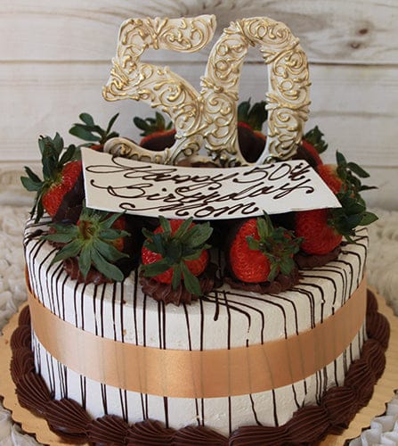 Introducing BD-000D: A white cake drizzled with chocolate, topped with chocolate-covered strawberries, a gold ribbon, a large "50" decor, and a cursive "Happy 50th Birthday" card on top.