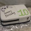 The CB-011O is a birthday cake shaped like a video game console with a controller on top, decorated with "Happy Birthday" and a big green number 10.
