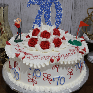 The BD-047 is a round birthday cake with red icing roses, a large blue 70 topper, golf-themed decor, red and blue writing, and a "Happy Birthday" message on white frosting.