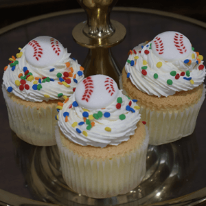 A CC-096A gold cupcake with chocolate filling is displayed on a glass tray with a gold stand.