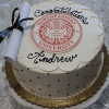 The GC-000H Northeastern is a round cake featuring the Northeastern University logo, “Congratulations Andrew” on top, black polka dots on the sides, and a white diploma with a black ribbon as decoration.