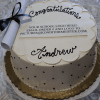 A white round cake with gold trim, black dots, and a scroll on top. “Congratulations Andrew” is written on it. For GC-0009: Don’t see your school logo? Send us your logo to add it to the design.