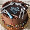 The FD-010 is a chocolate cake topped with colorful sprinkles, realistic edible tools, and “Happy Father’s Day” piped in blue icing.