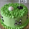 FD-011 is a round cake with green grass-like frosting, topped with a golf ball and a "#1 Dad" flag. Edible golf club decorations line the sides, and it is presented on a gold cake board.