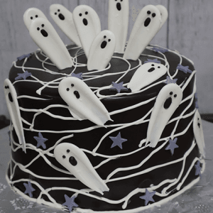 The HW-000A is a round chocolate cake topped with white icing ghosts, purple star shapes, and draped white icing lines for a spooky Halloween look.