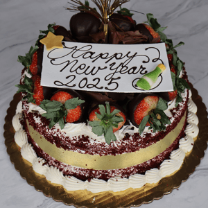 The NY-005 Red Velvet cake features chocolate-covered strawberries, a gold star, a “Happy New Year 2025” sign with a champagne bottle, white frosting, and a gold ribbon, beautifully displayed on a marble surface.