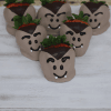 Six HW-021 strawberries are dipped in chocolate and decorated with cartoonish eyes, fangs, and expressive eyebrows to resemble vampires. They are arranged on a white surface for a festive presentation.