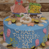 The CB-009L is a blue cake with seashells, cookies, fondant sea shapes, and Patrick & SpongeBob toppers. “WHAT’S FUNNIER THAN 24” is written on the cake with a white number 25 on top.