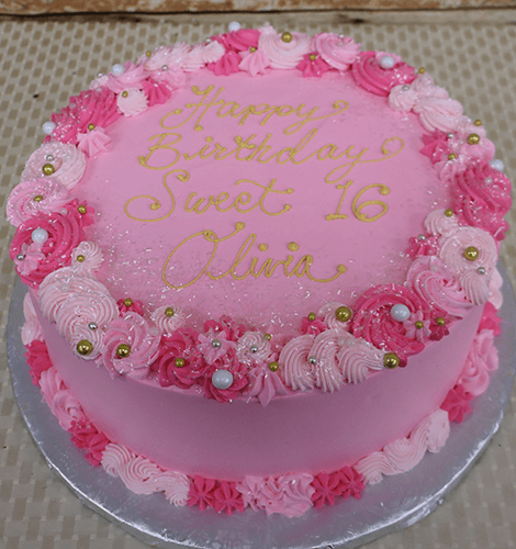 CB-018F is a round pink cake with “Happy Birthday Sweet 16 Olivia” written in yellow icing, decorated with pink and white swirls, sprinkles, and gold and white pearls.