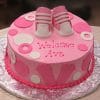 The BB-022 cake is a pink and white baby shower cake decorated with fondant baby shoes, circles, footprints, and “Welcome Ava” written in pink icing.