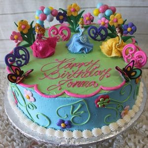 A colorful birthday cake named SC-020 Three Disney Princess, decorated with three princess figurines, flowers, butterflies, blue and green icing, and pink "Happy Birthday Donna" writing.