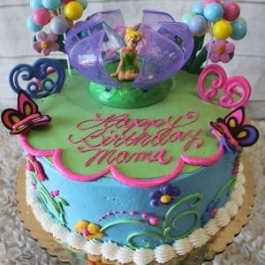 The SC-015 Tinker Bell is a colorful birthday cake featuring Tinker Bell on top, balloons, butterflies, flowers, and pink icing reading "Happy Birthday Mama" on green and blue frosting with scalloped pink edging.