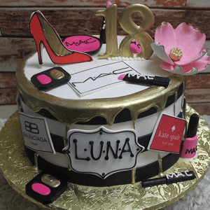 The BD-027B Designer Pink/Black is a round cake featuring gold accents, a pink high heel, large pink flower, makeup items, designer labels, a gold "18" topper, and "Luna" boldly displayed on the front.