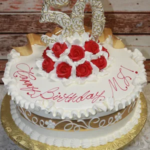 AN-002B is a round cake adorned with white icing, gold accents, red roses, and a large "50" topper. "Happy Birthday, MS!" is written in red icing on top, and the cake is presented on a gold tray.