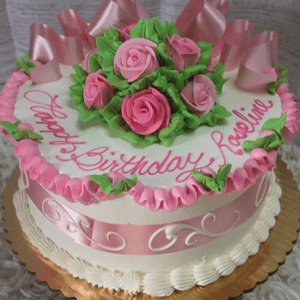 The BR-008 is a round birthday cake adorned with pink roses, green leaves, ribbon-like pink icing, and a pink ribbon around the side. "Happy Birthday, Roseline" is written in pink icing on top.