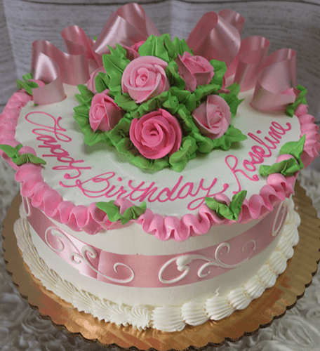 The BR-008 is a round birthday cake adorned with pink roses, green leaves, ribbon-like pink icing, and a pink ribbon around the side. "Happy Birthday, Roseline" is written in pink icing on top.