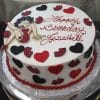 Round birthday cake (BD-140) decorated with red hearts, black and red lips, and a cartoon woman in a red dress. "Happy Birthday Jezzibell" is written in red icing on top.
