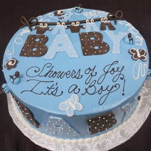 BB-019 is a round blue cake featuring butterflies, polka dots, and large BABY letters, with “Showers of Joy, It’s a Boy!” written in cursive on top.