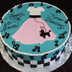BD-063 Poodle Skirt Music Notes: Round cake with 1950s poodle skirt design—pink skirt, white top, black poodle, music notes, checkerboard border. Blue frosting reads "Happy 70th Nana! Keep Dancing!.