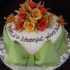 BR-058: A heart-shaped cake with a green bow, adorned with red and yellow fondant roses, butterfly decorations, and the inscription “Together is a wonderful place to be” in elegant script.
