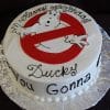 CB-010B is a round birthday cake with the Ghostbusters logo and “Happy Birthday Ducky” on top. The cake’s side features “Who you gonna call?” written in black icing.