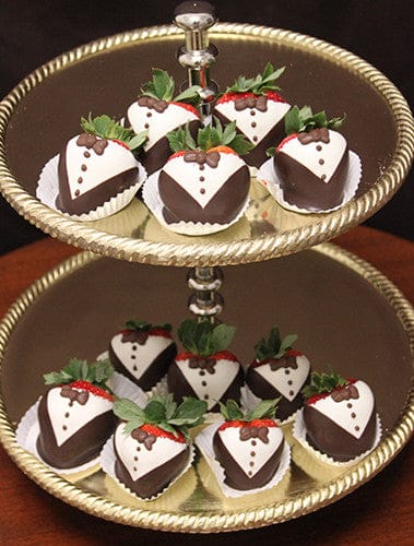 ST-002 Tuxedo Strawberries, decorated like tiny tuxedos, are elegantly arranged on both tiers of a silver tray.
