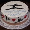 The CB-026B is a round birthday cake with white icing, black gymnast silhouettes, red hearts, blue "Happy 8th Birthday Shayndel" script, and a gymnast in a split leap on top.
