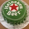 The BD-025 Heineken is a round cake designed as a green beer bottle cap with white "Heineken Beer" text and a large red star in the center, presented on a silver floral-patterned tray.