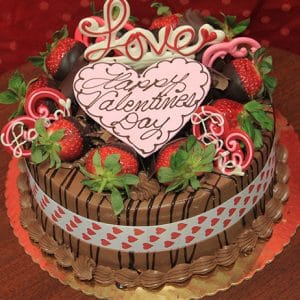 The VC-002 Display Chocolate Mousse cake features chocolate-dipped strawberries, pink and white chocolate hearts, a ribbon with red hearts, and a "Happy Valentines Day with Love" sign on top.