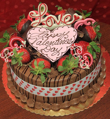 The VC-002 Display Chocolate Mousse cake features chocolate-dipped strawberries, pink and white chocolate hearts, a ribbon with red hearts, and a "Happy Valentines Day with Love" sign on top.