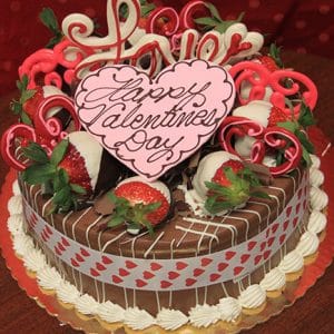 The VC-003 Display Chocolate Oreo Cake features chocolate-dipped strawberries, heart-shaped decorations, and a pink heart reading "Happy Valentine’s Day" on a gold platter with a red heart ribbon.