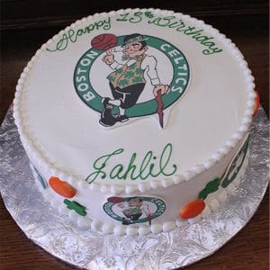 The ST-005 Celtics round birthday cake features the Boston Celtics logo, green "Happy 15th Birthday Jahlil" writing, plus basketball and shamrock decorations on the sides.