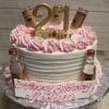 The BD-024M PinkTitos cake features white layers, pink frosting, gold beads, a gold 21 topper, and mini Tito’s vodka bottles. A plaque in pink script says "Happy Birthday Madison." The cake is displayed on a silver board.