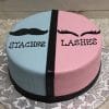 The BB-053 cake is round and split in half: the left side is blue with a black mustache and "STACHES," while the right side is pink with eyelashes and "LASHES." It sits on a patterned white board.