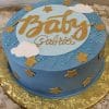 The BB-056 is a round blue cake with gold stars, white clouds, and blue sprinkles. "Baby Gabriel" appears in gold script on top, and the cake sits on a gold-patterned board.
