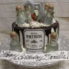 The BD-024V birthday cake features mini Patron tequila bottles, a silver 21 topper, chocolate drips, and strawberries. A white plaque with "Happy Birthday Danielle!" in cursive completes the festive design.